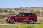 Picture of a driving 2017 Honda CR-V Touring AWD in Molten Lava Pearl from a left side perspective