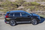 Picture of a driving 2017 Honda CR-V Touring AWD in Crystal Black Pearl from a right side perspective