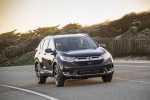Picture of a driving 2017 Honda CR-V Touring AWD in Crystal Black Pearl from a front right perspective