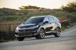 Picture of a driving 2017 Honda CR-V Touring AWD in Crystal Black Pearl from a front left three-quarter perspective