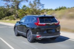 Picture of a driving 2017 Honda CR-V Touring AWD in Crystal Black Pearl from a rear left perspective