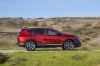 Picture of a driving 2018 Honda CR-V Touring AWD in Molten Lava Pearl from a right side perspective