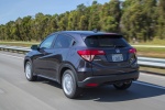 Picture of a driving 2016 Honda HR-V in Mulberry Metallic from a rear left perspective