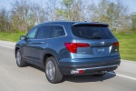 Picture of a driving 2016 Honda Pilot AWD in Steel Sapphire Metallic from a rear left perspective