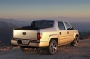Picture of a 2013 Honda Ridgeline in Alabaster Silver Metallic from a rear right three-quarter perspective