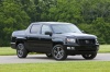 Picture of a 2013 Honda Ridgeline in Crystal Black Pearl from a front right three-quarter perspective