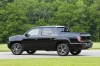 Picture of a 2013 Honda Ridgeline in Crystal Black Pearl from a rear left three-quarter perspective