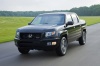 Picture of a driving 2013 Honda Ridgeline in Crystal Black Pearl from a front left perspective