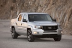 Picture of a driving 2013 Honda Ridgeline in Alabaster Silver Metallic from a front right perspective