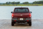 Picture of a 2017 Honda Ridgeline AWD in Deep Scarlet Pearl from a rear perspective