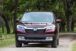 Picture of a driving 2017 Honda Ridgeline AWD in Deep Scarlet Pearl from a frontal perspective