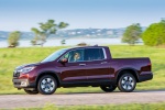 Picture of a driving 2017 Honda Ridgeline AWD in Deep Scarlet Pearl from a side perspective