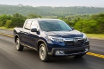 Picture of a driving 2017 Honda Ridgeline AWD in Obsidian Blue Pearl from a front right perspective