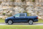 Picture of a driving 2017 Honda Ridgeline AWD in Obsidian Blue Pearl from a side perspective
