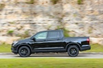 Picture of a driving 2017 Honda Ridgeline Black Edition AWD in Crystal Black Pearl from a side perspective