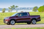 Picture of a driving 2018 Honda Ridgeline AWD in Deep Scarlet Pearl from a side perspective