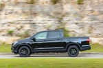 Picture of a driving 2018 Honda Ridgeline Black Edition AWD in Crystal Black Pearl from a side perspective