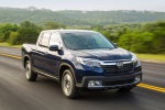 Picture of a driving 2019 Honda Ridgeline AWD in Obsidian Blue Pearl from a front right perspective