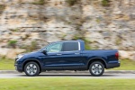 Picture of a driving 2019 Honda Ridgeline AWD in Obsidian Blue Pearl from a side perspective
