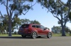 Picture of a 2014 Hyundai Santa Fe in Regal Red Pearl from a rear right three-quarter perspective