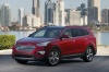 Picture of a 2014 Hyundai Santa Fe in Regal Red Pearl from a front left three-quarter perspective