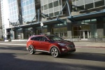 Picture of a driving 2014 Hyundai Santa Fe in Regal Red Pearl from a front right three-quarter perspective
