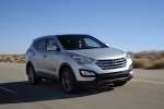Picture of a driving 2014 Hyundai Santa Fe Sport in Moonstone Silver from a front right three-quarter perspective