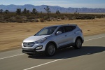 Picture of a driving 2014 Hyundai Santa Fe Sport in Moonstone Silver from a front left three-quarter perspective