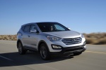 Picture of a driving 2016 Hyundai Santa Fe Sport in Sparkling Silver from a front right three-quarter perspective