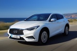 Picture of a driving 2018 Infiniti QX30 in Majestic White from a front left perspective
