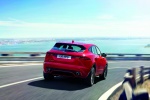 Picture of a driving 2018 Jaguar E-Pace P300 R-Dynamic AWD in Firenze Red Metallic from a rear right perspective