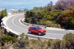 Picture of a driving 2018 Jaguar E-Pace P300 R-Dynamic AWD in Firenze Red Metallic from a front right three-quarter perspective