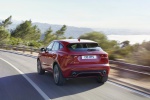 Picture of a driving 2018 Jaguar E-Pace P300 R-Dynamic AWD in Firenze Red Metallic from a rear left perspective