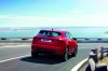 Picture of a driving 2019 Jaguar E-Pace P300 R-Dynamic AWD in Firenze Red Metallic from a rear right perspective
