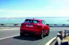 Picture of a driving 2020 Jaguar E-Pace P300 R-Dynamic AWD in Firenze Red Metallic from a rear right perspective