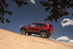 Picture of a 2017 Jeep Cherokee Trailhawk 4WD in Deep Cherry Red Crystal Pearlcoat from a rear left three-quarter perspective