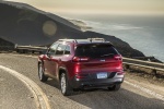 Picture of a driving 2017 Jeep Cherokee Latitude in Deep Cherry Red Crystal Pearlcoat from a rear left three-quarter perspective