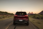 Picture of a driving 2017 Jeep Cherokee Limited 4WD in Deep Cherry Red Crystal Pearlcoat from a rear perspective
