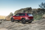 Picture of a 2017 Jeep Cherokee Trailhawk 4WD in Deep Cherry Red Crystal Pearlcoat from a rear left three-quarter perspective