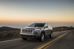 Picture of a driving 2017 Jeep Cherokee Limited 4WD in Billet Silver Metallic Clearcoat from a front left three-quarter perspective
