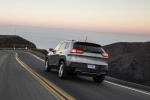 Picture of a driving 2017 Jeep Cherokee Limited 4WD in Billet Silver Metallic Clearcoat from a rear left perspective