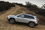 Picture of a driving 2017 Jeep Cherokee Trailhawk 4WD in Billet Silver Metallic Clearcoat from a side perspective