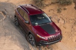 Picture of a driving 2017 Jeep Cherokee Trailhawk 4WD in Deep Cherry Red Crystal Pearlcoat from a front right perspective