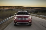 Picture of a driving 2014 Jeep Grand Cherokee Summit 4WD in Deep Cherry Red Crystal Pearlcoat from a frontal perspective