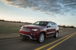 Picture of a driving 2014 Jeep Grand Cherokee Summit 4WD in Deep Cherry Red Crystal Pearlcoat from a front left three-quarter perspective