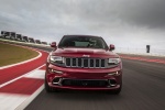 Picture of a driving 2014 Jeep Grand Cherokee SRT 4WD in Redline 2 Coat Pearl from a frontal perspective