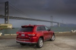 Picture of a 2015 Jeep Grand Cherokee Summit 4WD in Deep Cherry Red Crystal Pearlcoat from a rear right three-quarter perspective