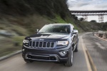 Picture of a driving 2015 Jeep Grand Cherokee Limited Diesel 4WD in Granite Crystal Metallic Clearcoat from a front left perspective