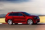 Picture of a driving 2015 Jeep Grand Cherokee SRT 4WD in Redline 2 Coat Pearl from a front right three-quarter perspective