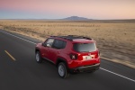 Picture of a driving 2016 Jeep Renegade Latitude 4WD in Colorado Red from a rear left three-quarter perspective
